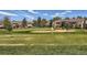 Picturesque view of the golf course, showcasing the meticulously maintained putting green and sand trap at 13598 E Asbury Dr, Aurora, CO 80014