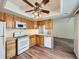 Well-lit kitchen with wood cabinets, modern appliances, and ample counter space at 13598 E Asbury Dr, Aurora, CO 80014