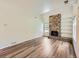 Spacious living room featuring a striking stone fireplace and wood-look floors at 13598 E Asbury Dr, Aurora, CO 80014