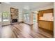 Bright living room with stone fireplace, built-in shelves, and wood-look floors at 13598 E Asbury Dr, Aurora, CO 80014