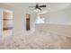 Inviting loft with a ceiling fan and open access to a tiled bathroom and walk-in closet at 13598 E Asbury Dr, Aurora, CO 80014