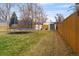 Spacious backyard with a trampoline, storage sheds, and wooden fence at 424 S Leyden St, Denver, CO 80224