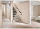 Carpeted basement stairs lead to a basement with paneled walls and a finished bedroom at 424 S Leyden St, Denver, CO 80224