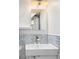 Stylish bathroom sink with subway tile backsplash, modern faucet, and large mirror at 424 S Leyden St, Denver, CO 80224