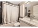 Bathroom featuring dark tiled walls, tub and shower, vanity and modern medicine cabinet at 424 S Leyden St, Denver, CO 80224