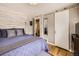 Main bedroom with sliding barn door and modern wall accent at 424 S Leyden St, Denver, CO 80224