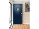 Stylish front door with glass insert, complemented by a decorative clock and hardwood floors in entryway at 424 S Leyden St, Denver, CO 80224