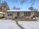 Ranch home with snowy front yard and inviting porch at 424 S Leyden St, Denver, CO 80224