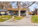 Charming home exterior with landscaped front yard, mature tree, and convenient driveway at 424 S Leyden St, Denver, CO 80224