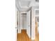 Hallway with hardwood floors and white doors to closet, bathroom and living spaces at 424 S Leyden St, Denver, CO 80224