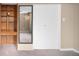 Hallway area with doorway mirror and built-in wood shelves and a closet with white door at 424 S Leyden St, Denver, CO 80224