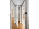 Hallway with hardwood floors and a view of a closet, the front yard and an adjacent room at 424 S Leyden St, Denver, CO 80224