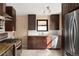 Well-equipped kitchen with stainless steel appliances, dark cabinets, and granite countertops at 424 S Leyden St, Denver, CO 80224