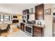 Well-equipped kitchen with stainless steel appliances, dark wood cabinets, and an open layout to dining area at 424 S Leyden St, Denver, CO 80224