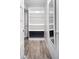 Walk-in closet with wood-look floors, white shelving, and a full-length mirror at 424 S Leyden St, Denver, CO 80224