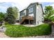 Large backyard features green lawn, trees, and exterior of home at 5550 Fox Meadow Ave, Highlands Ranch, CO 80130