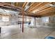 Unfinished basement with exposed ceiling and beams provides ample space for recreation and storage at 5550 Fox Meadow Ave, Highlands Ranch, CO 80130