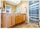 Bathroom featuring light wood cabinet, double sinks, and tile floor at 5550 Fox Meadow Ave, Highlands Ranch, CO 80130