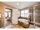 Bathroom featuring a soaking tub with tile surround and a glass-enclosed shower at 5550 Fox Meadow Ave, Highlands Ranch, CO 80130
