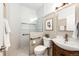 Modern bathroom featuring wood cabinet sink and new shower with safety bars at 5550 Fox Meadow Ave, Highlands Ranch, CO 80130