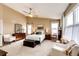 Bright bedroom with vaulted ceiling, cozy furniture, and an abundance of natural light from large windows at 5550 Fox Meadow Ave, Highlands Ranch, CO 80130