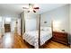 Bright bedroom featuring wood floors, a four-poster bed, and ample closet space at 5550 Fox Meadow Ave, Highlands Ranch, CO 80130