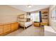 bedroom with wooden bunk beds, carpet, and bright light at 5550 Fox Meadow Ave, Highlands Ranch, CO 80130