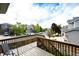 Deck with wood railing overlooks neighborhood and trees at 5550 Fox Meadow Ave, Highlands Ranch, CO 80130