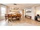 Dining area with a large wooden table, staircase, and stylish lighting fixture at 5550 Fox Meadow Ave, Highlands Ranch, CO 80130