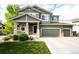 Inviting two-story home with a covered front porch and well-maintained lawn at 5550 Fox Meadow Ave, Highlands Ranch, CO 80130