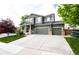 Beautiful two-story home featuring an attached three-car garage and manicured landscaping at 5550 Fox Meadow Ave, Highlands Ranch, CO 80130