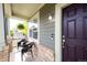 Cozy front porch with seating and a hanging fern, next to the front door at 5550 Fox Meadow Ave, Highlands Ranch, CO 80130