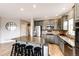 Well-lit kitchen with granite countertops, stainless steel appliances, and a center island with seating at 5550 Fox Meadow Ave, Highlands Ranch, CO 80130