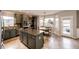 Spacious kitchen with gray cabinets, granite countertops, stainless steel appliances, and adjacent breakfast nook at 5550 Fox Meadow Ave, Highlands Ranch, CO 80130