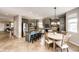A modern kitchen with stainless steel appliances and a center island with bar stool seating, and an adjacent dining area at 5550 Fox Meadow Ave, Highlands Ranch, CO 80130