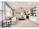 Spacious living room with large windows, neutral tones, and a decorative fireplace with built-in shelving at 5550 Fox Meadow Ave, Highlands Ranch, CO 80130