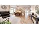 Elegant living room with a piano, dining table, and stylish staircase at 5550 Fox Meadow Ave, Highlands Ranch, CO 80130