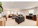 Spacious living room featuring neutral walls, ceiling fan, plush seating, and a dedicated workspace at 5550 Fox Meadow Ave, Highlands Ranch, CO 80130