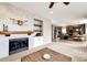 Inviting living room with fireplace, built-in shelving, and view to kitchen and breakfast nook at 5550 Fox Meadow Ave, Highlands Ranch, CO 80130