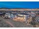 Aerial night view of the home showing backyard, community lights, and city lights in the distance at 2957 Eagle Wing Way, Castle Rock, CO 80109