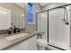 Modern bathroom featuring a shower with a black frame and hardware, and a gray countertop at 2957 Eagle Wing Way, Castle Rock, CO 80109