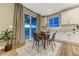 Cozy breakfast nook with a table, chairs, large windows with curtains, and access to outdoor living space at 2957 Eagle Wing Way, Castle Rock, CO 80109