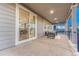 Relaxing covered patio with outdoor seating and sliding glass doors to the home's interior at 2957 Eagle Wing Way, Castle Rock, CO 80109