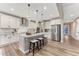 Spacious kitchen with an island, stainless steel appliances, white cabinetry, and wood flooring at 2957 Eagle Wing Way, Castle Rock, CO 80109