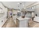 Bright kitchen featuring white cabinets, stainless steel appliances, quartz counters and a large island at 2957 Eagle Wing Way, Castle Rock, CO 80109