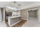 Basement kitchenette features an island and stainless steel refrigerator and view to carpeted room at 2957 Eagle Wing Way, Castle Rock, CO 80109