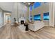 Bright living room with a fireplace, large windows, high ceilings, and wood floors at 2957 Eagle Wing Way, Castle Rock, CO 80109