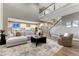 Open-concept living room showcases a modern kitchen, a cozy seating area, and a staircase leading to the second floor at 2957 Eagle Wing Way, Castle Rock, CO 80109