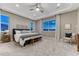 Relaxing main bedroom features soft lighting, a ceiling fan, plush carpet, and ample natural light at 2957 Eagle Wing Way, Castle Rock, CO 80109