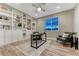 Inviting home office with custom built-in shelving, a ceiling fan, and a well-lit workspace at 2957 Eagle Wing Way, Castle Rock, CO 80109